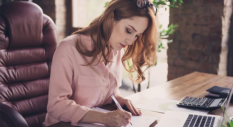 woman writing in a paper