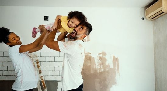 Couple playing with their son