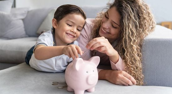 Mom and son with their piggy bank