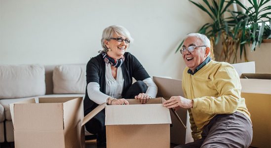 Senior couple happy together while opening a box