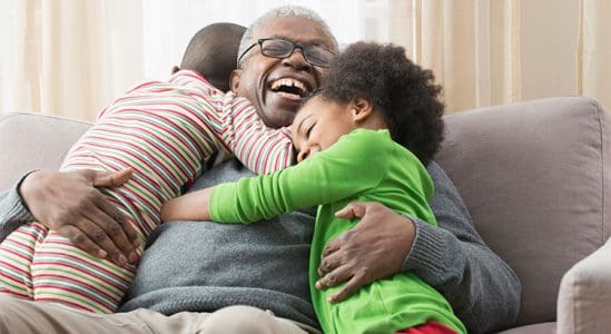 Grand father hugging his grand daughter and grand son