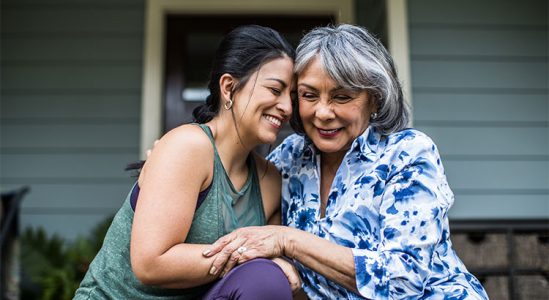 Young woman and senior woman hugging each other