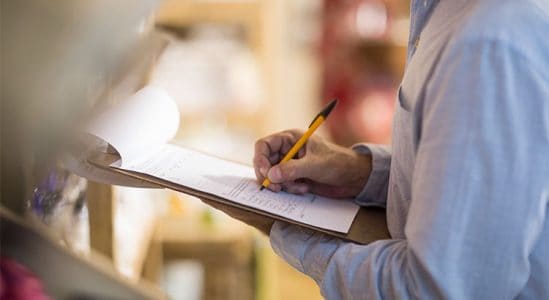 Man writing in his clipboard