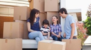 Couple with their 2 young kids while moving in