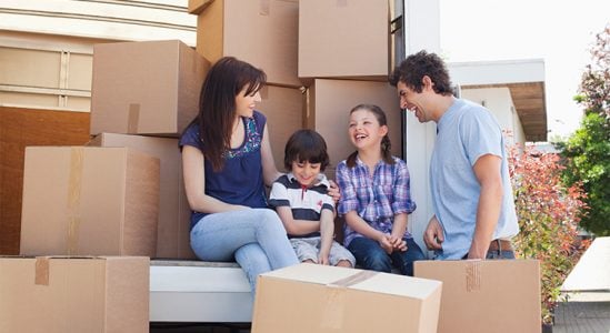 Couple with their 2 young kids while moving in
