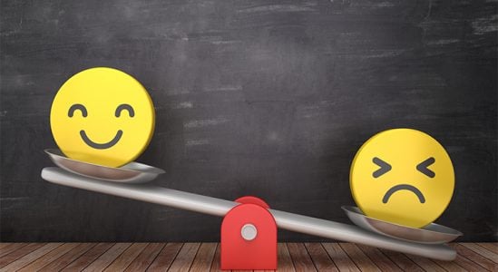 Weighing scale with happy face on left side and sad face on the right