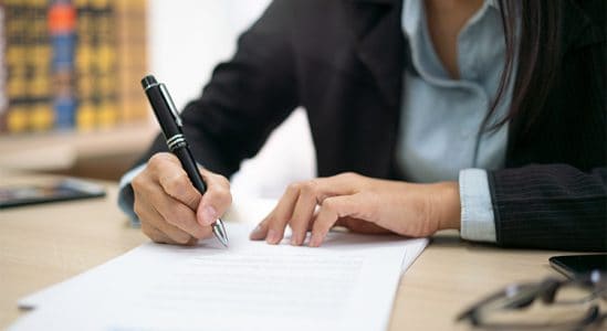 Woman writing in paper