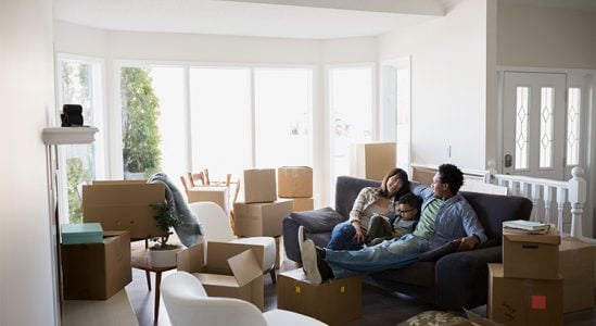 Family resting while moving in to their new house
