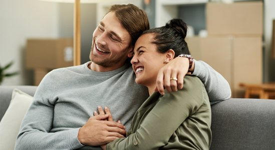 Happy young couple in sofa