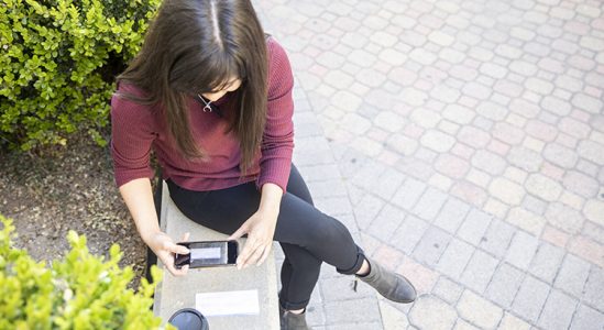 Woman taking a photo of a paper