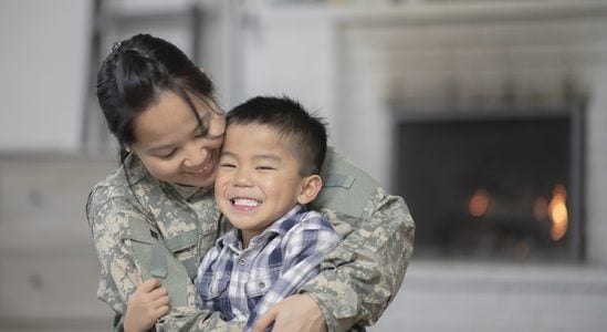 Son being hugged by his mom from military
