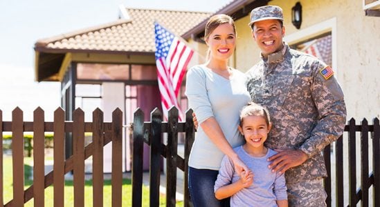 Mom, dad from military and son taking a family picture