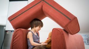 Kid playing on his small house