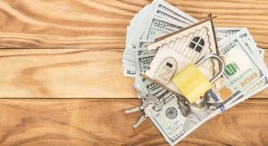 Toy model house with dollar bills