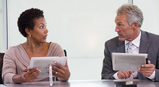 Two professional discussing in a table