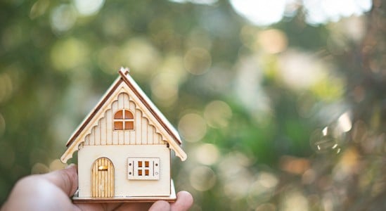 Toy model house in a hand