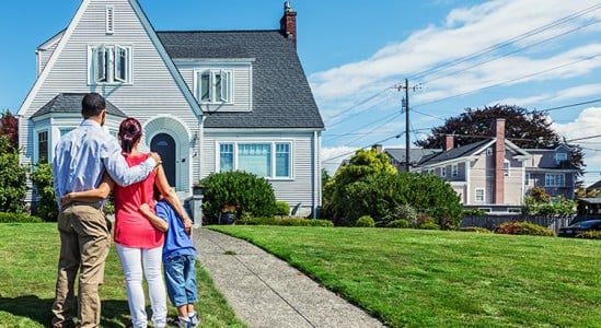 Family in front of a new home