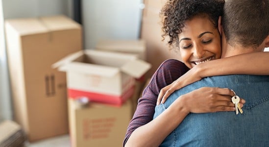 Young couple hugging each other while moving in