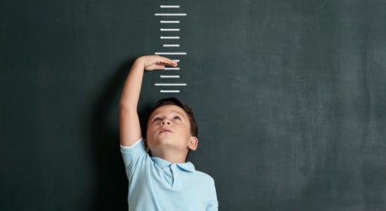 Kid measuring his height