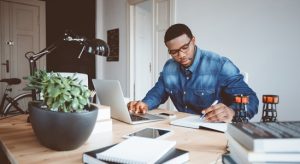 Man working with his laptop in his table