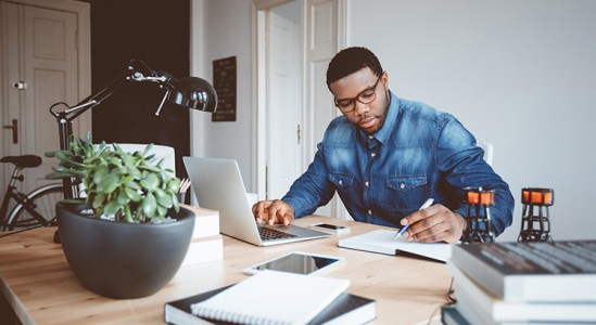 Man working with his laptop in his table