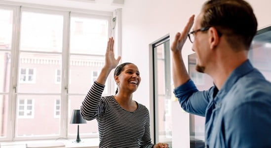 Young couple doing high five