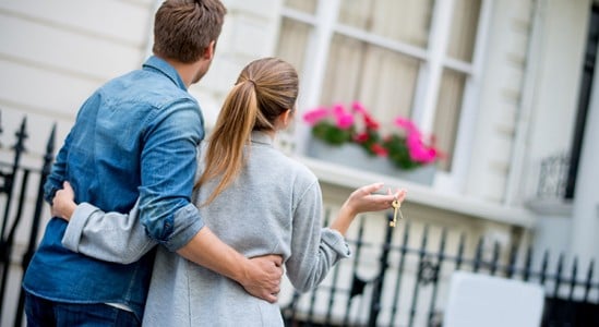 Couple in front of a home