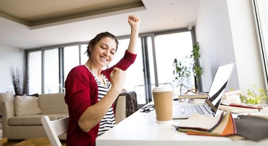 Young woman dancing in front of her desk