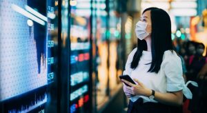 Woman looking out while holding phone