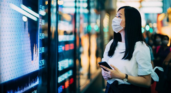 Woman looking out while holding phone