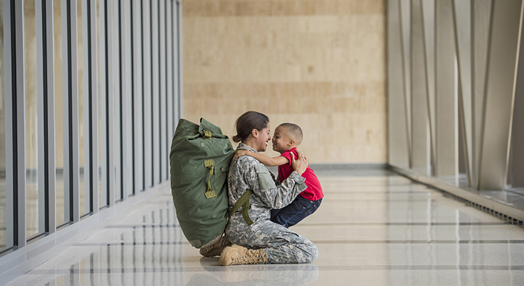 African American soldier hugging son in airport