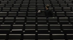 Man Sitting On Chair In Auditorium
