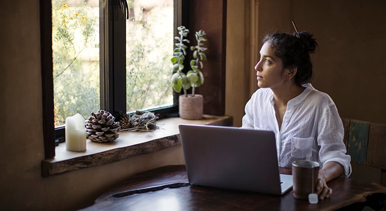 Mixed-race Young Adult Woman Works at Home Using Laptop Computer
