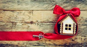 small toy house with red ribbon and key