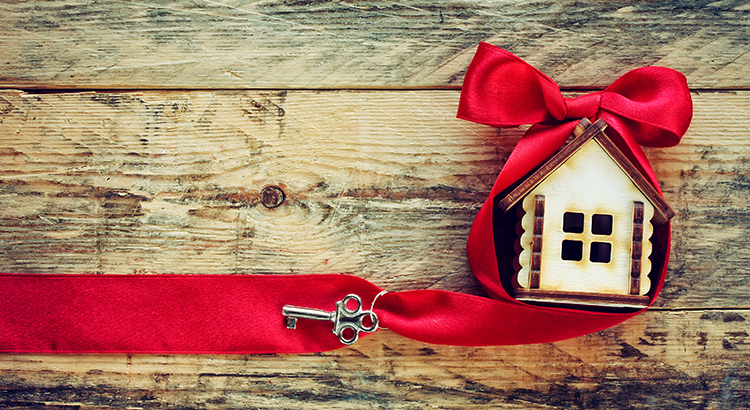 small toy house with red ribbon and key