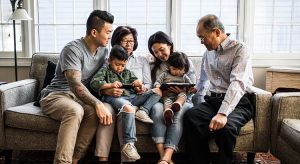 Family together in a sofa, happily talking with each other