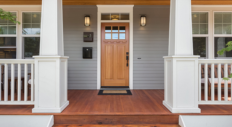 Facade of home with covered porch and door