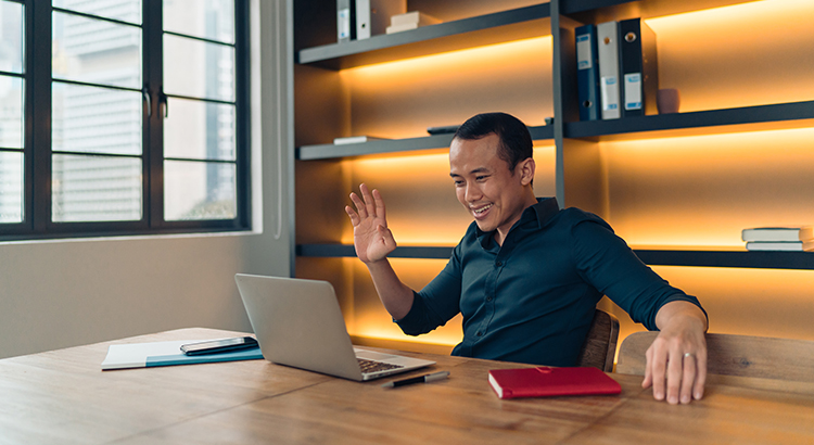 Asian man looking at the his laptop