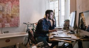 Young creative man working in his home office
