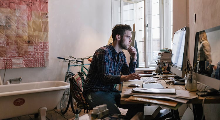 Young creative man working in his home office