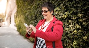 Senior woman using her smartphone and smiling