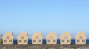 wooden toy house against blue sky