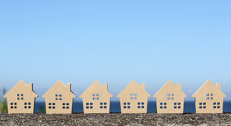 wooden toy house against blue sky