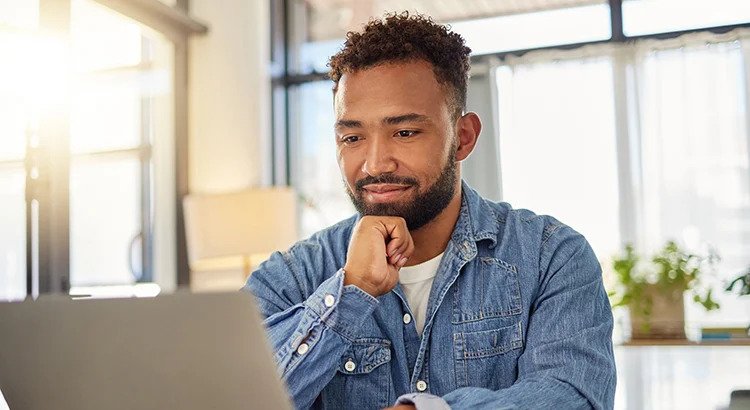 Man on his computer thinking about work