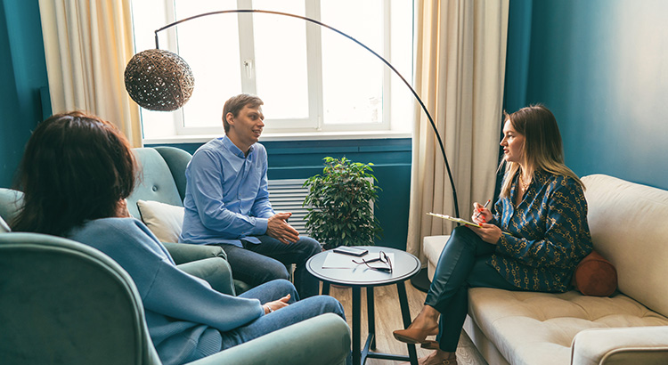 Three persons talking in the office