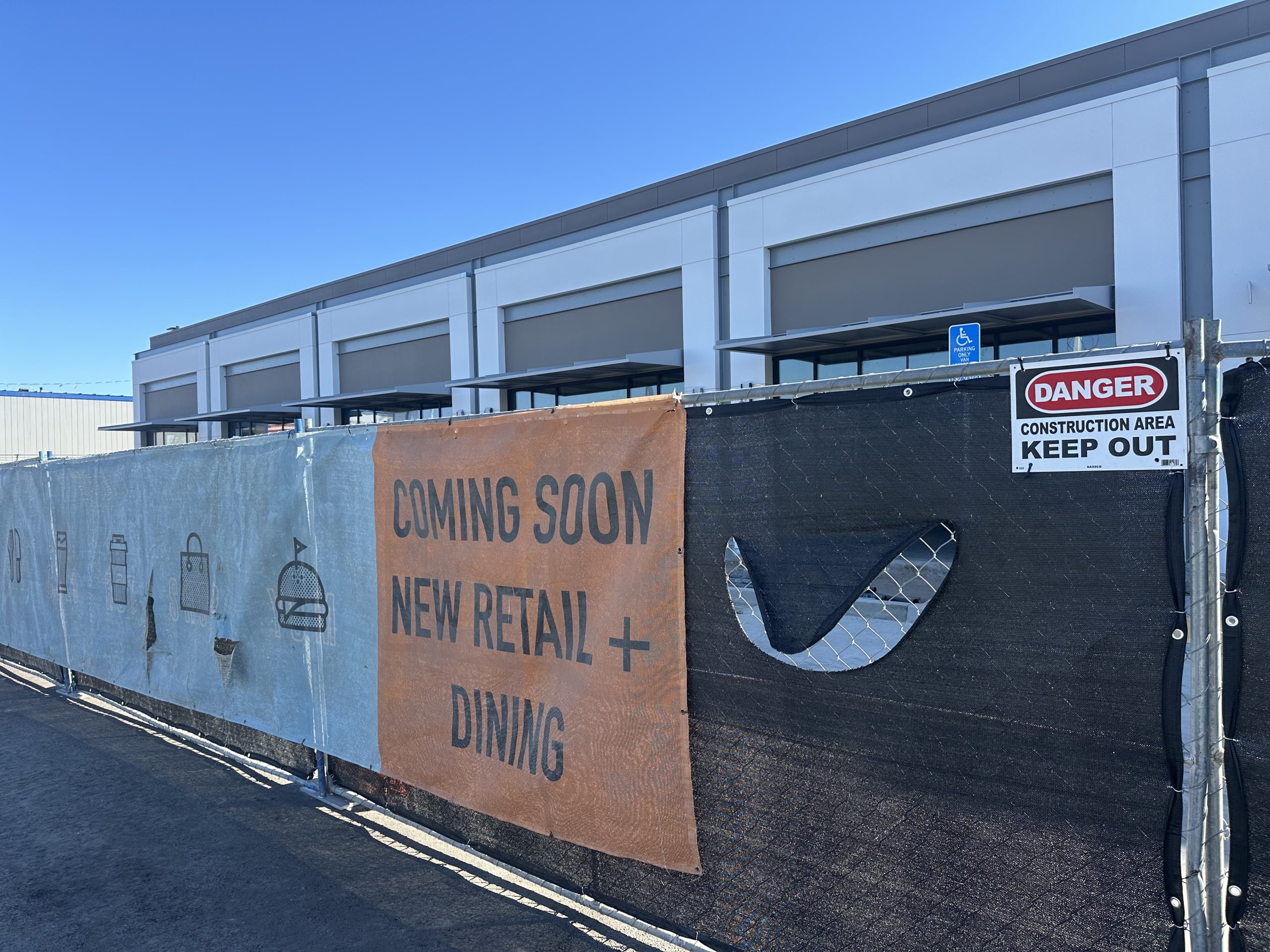 The Canopy construction fence announcing new retail and dining at Great Park