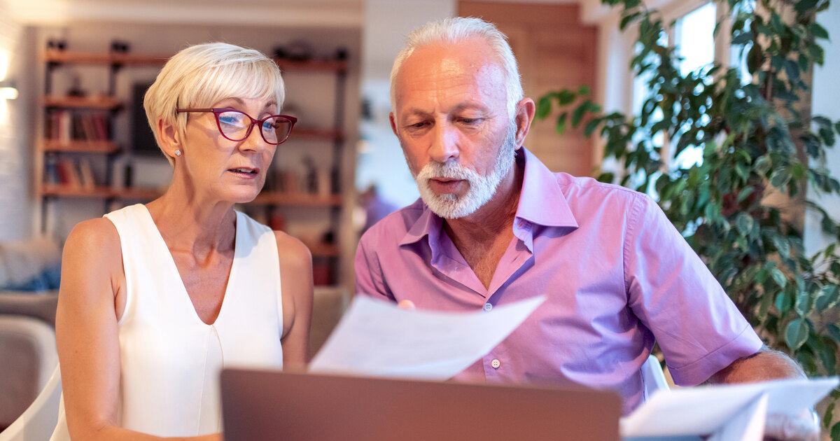 Orange County homeowners reviewing financial documents before planning their next home purchase.